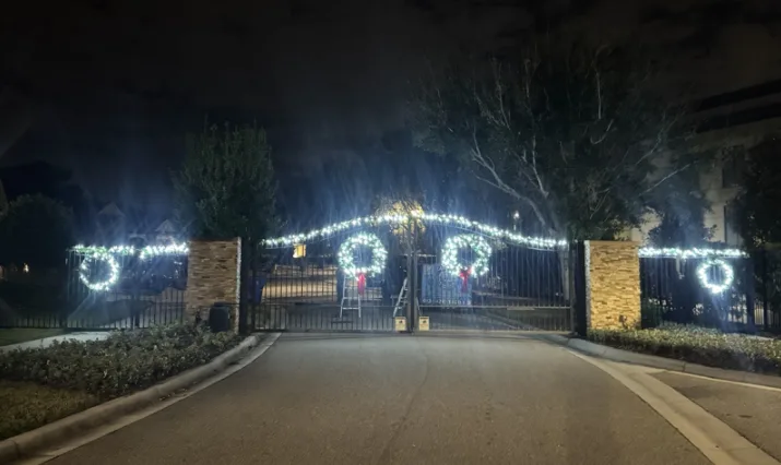 Gated community entrance in Wesley Chapel, FL decorated with lit wreaths and garland